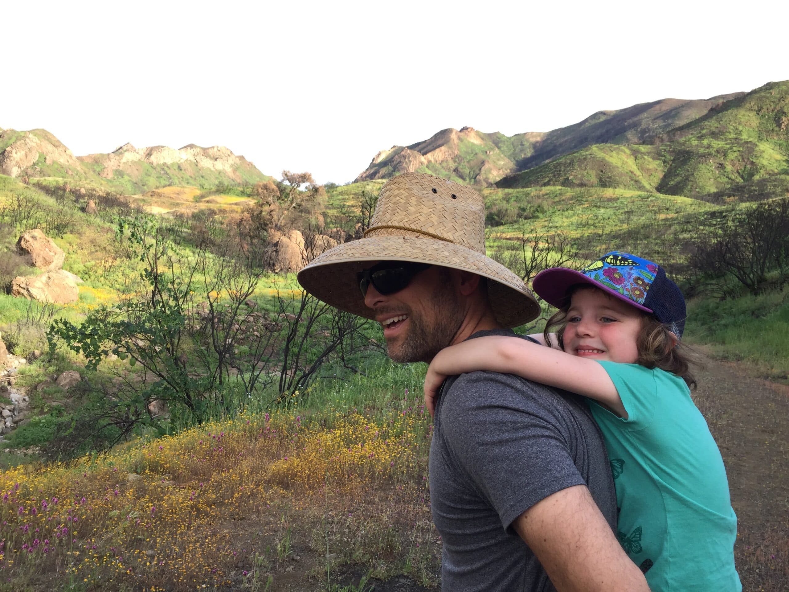 First Steps for Kids Director of Research Jonathan Tarbox carrying his son
