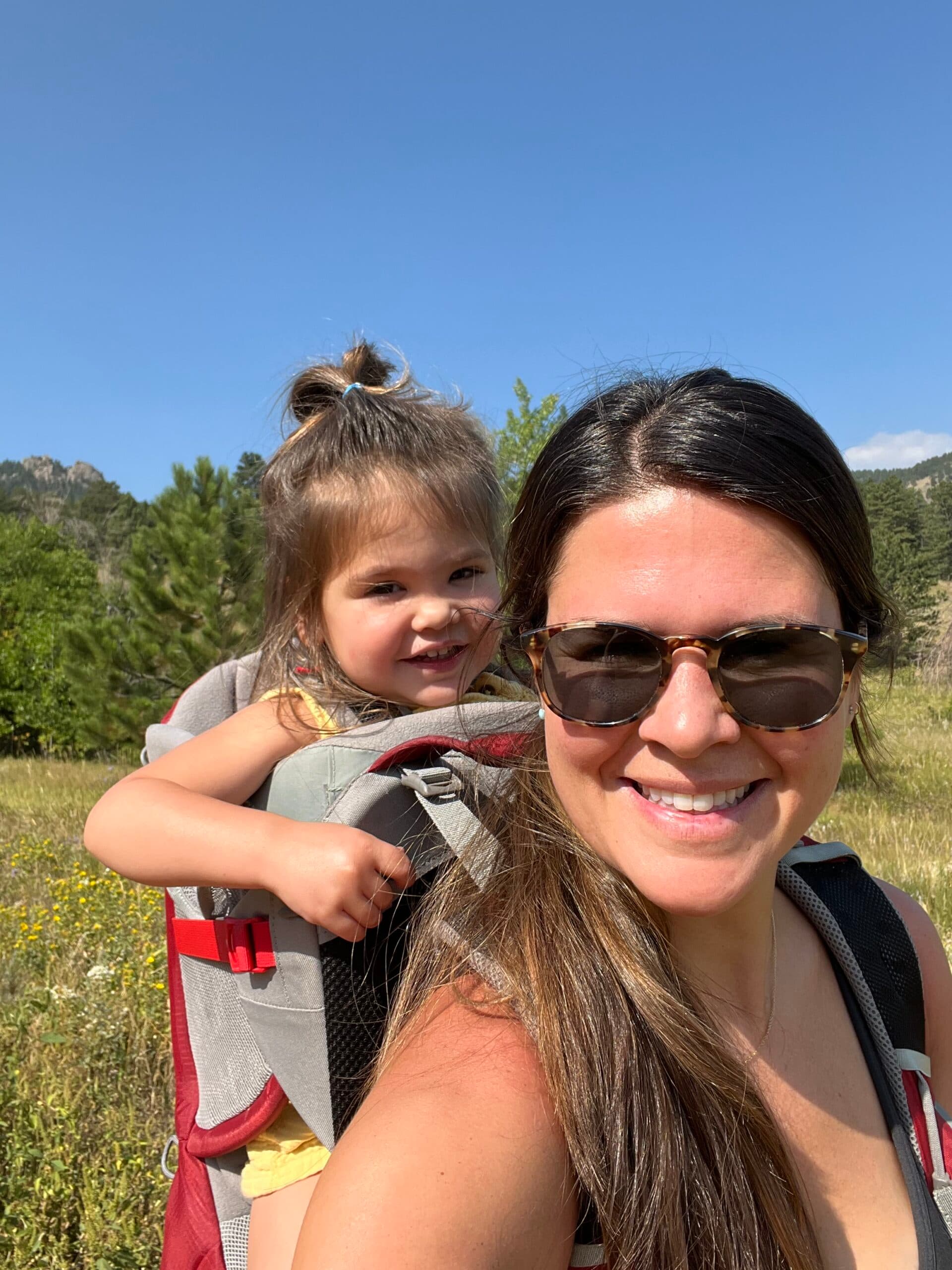 First Steps for Kids Clinical Operations Analyst Jenna Battaglia carrying a child