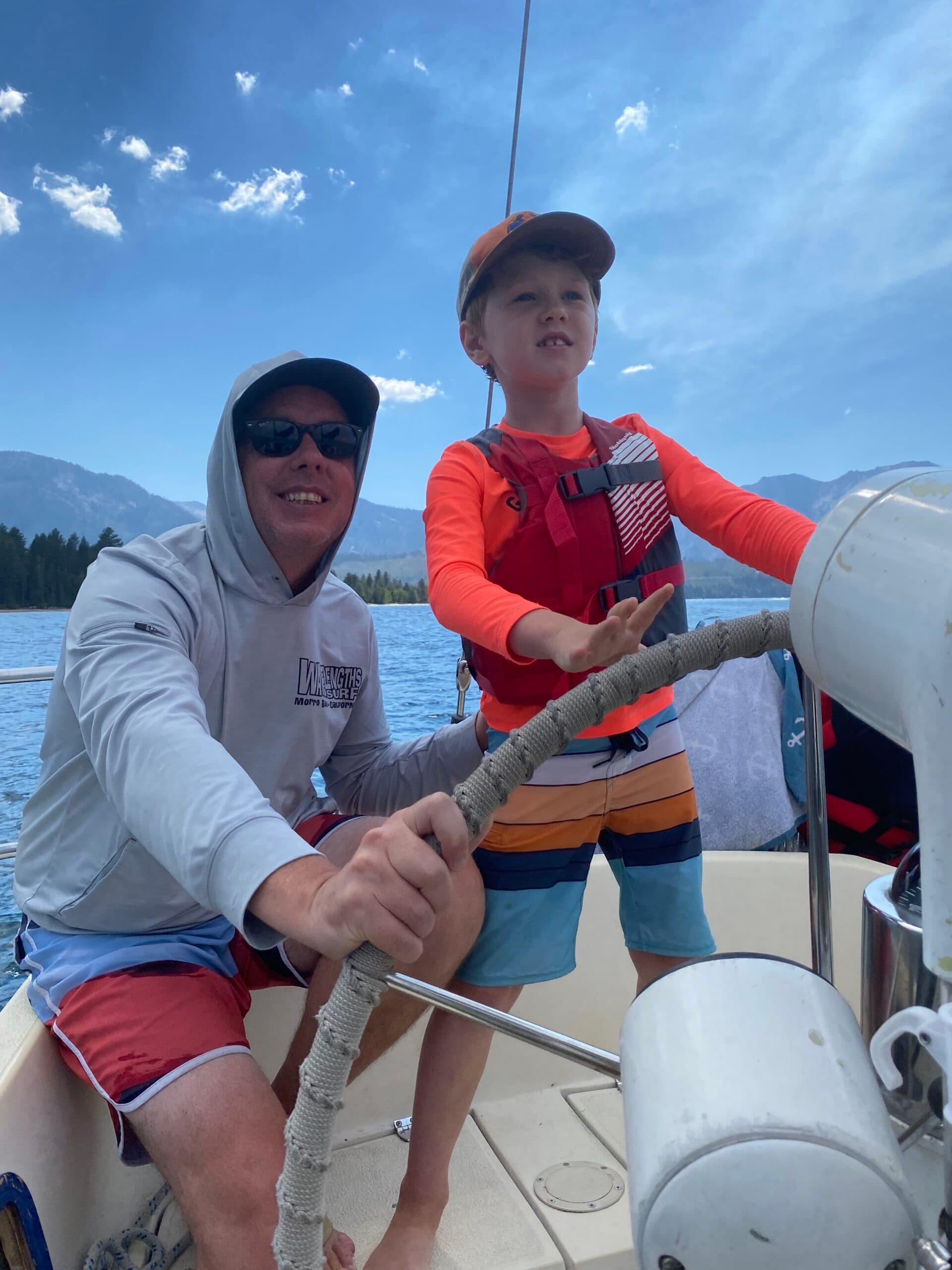 First Steps for Kids CEO Matt McAlear on a boat with child