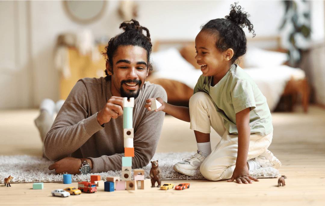 An adult and child playing with blocks
