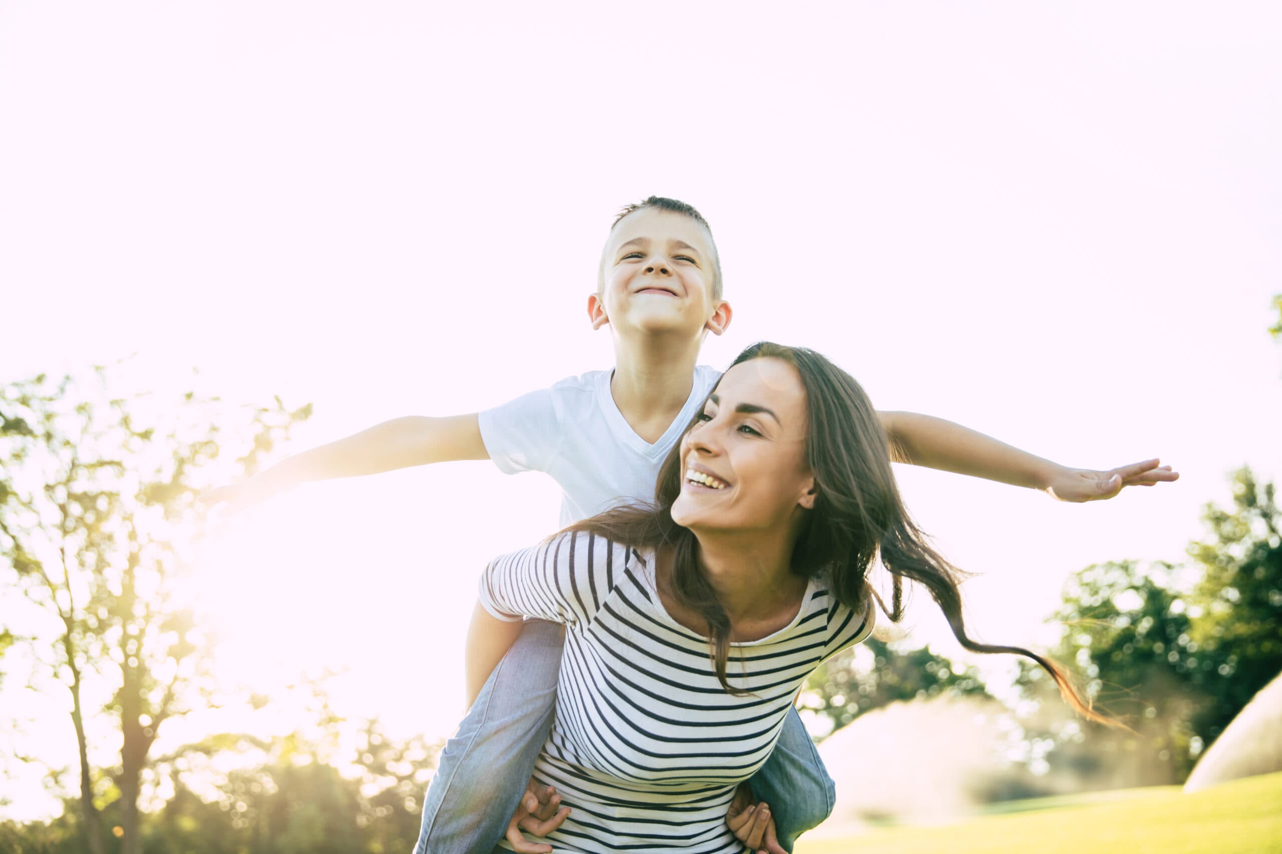 Women and young boy playing