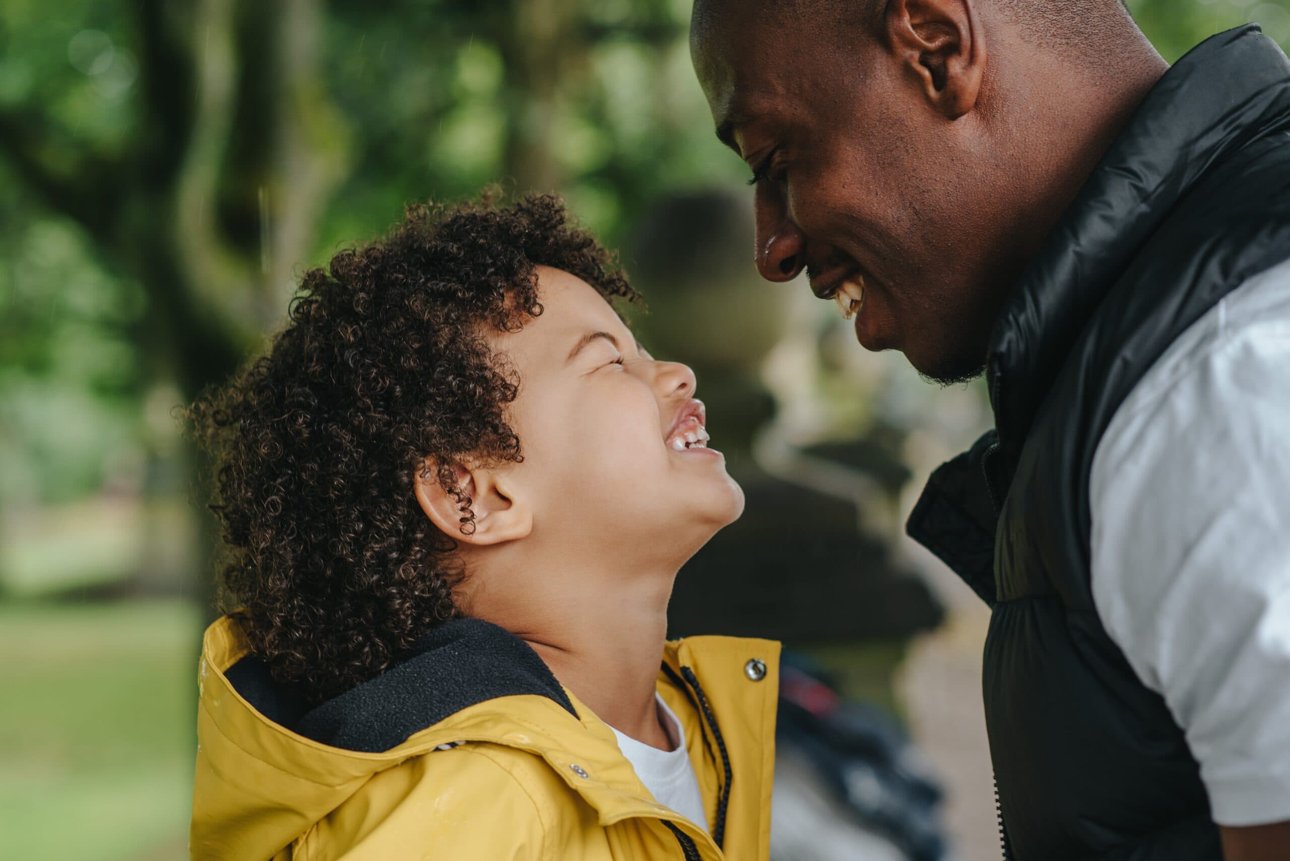 Young boy and father smiling