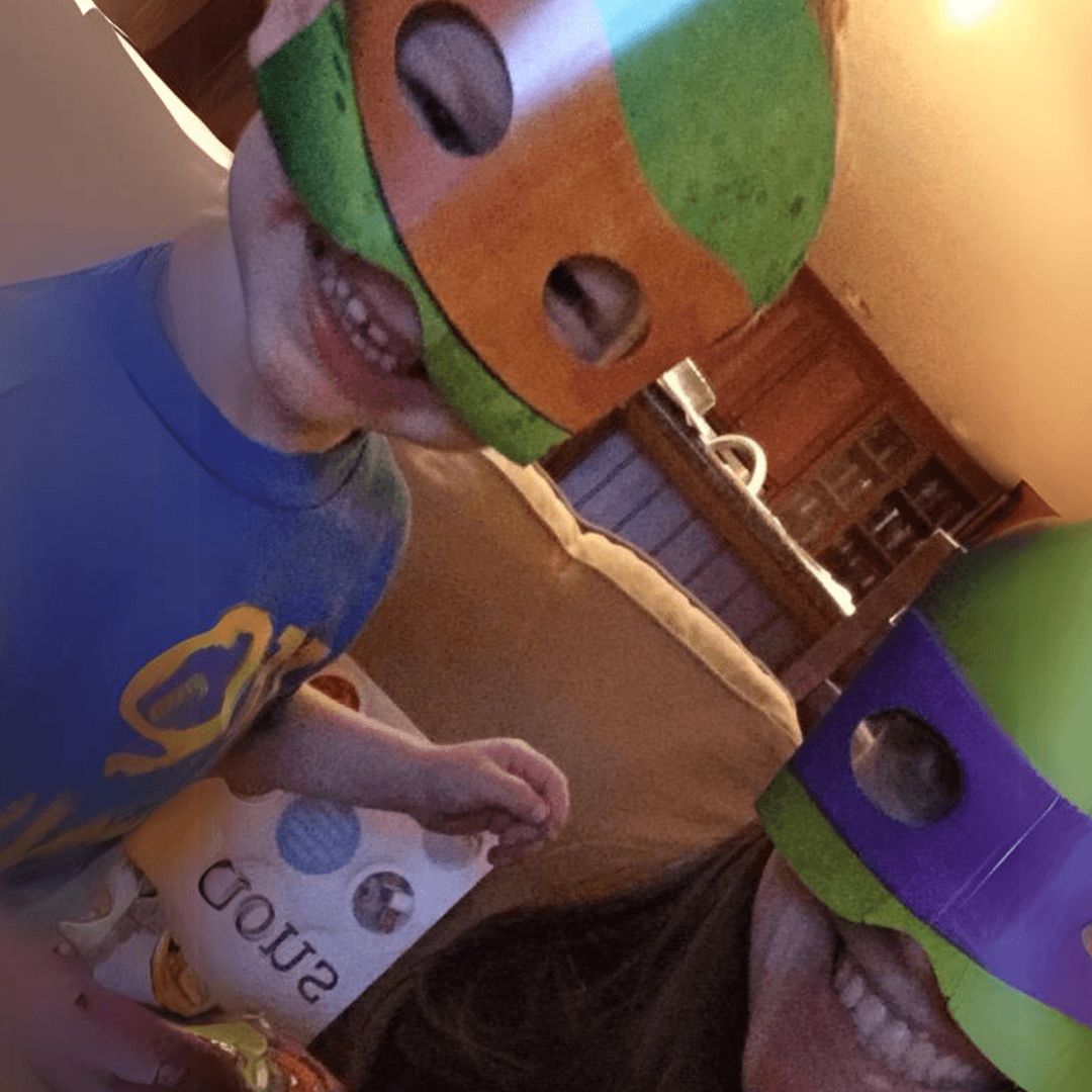 Walnut Creek Director Caitlin Wineman and child wearing teenage mutant ninja turtle masks