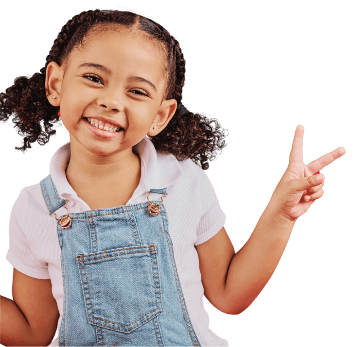 A smiling child with two fingers in the air making a peace sign