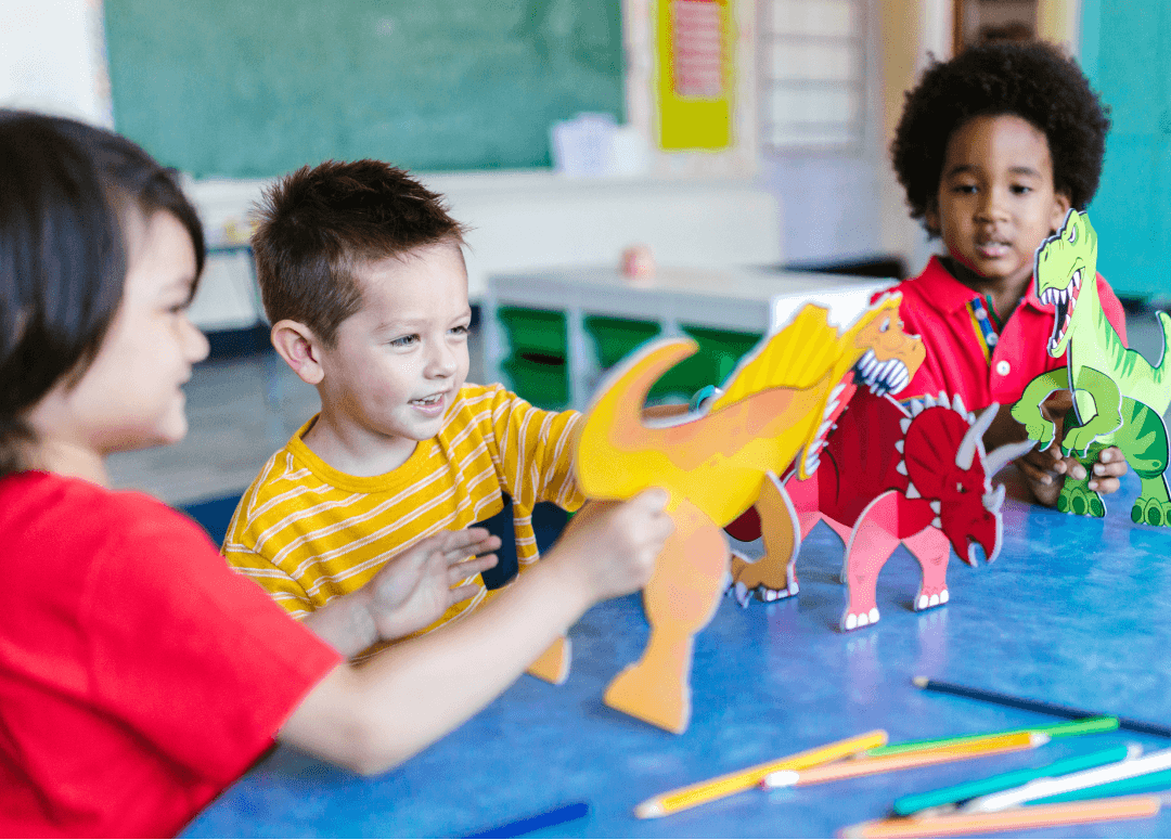Children playing with dinosaur toys