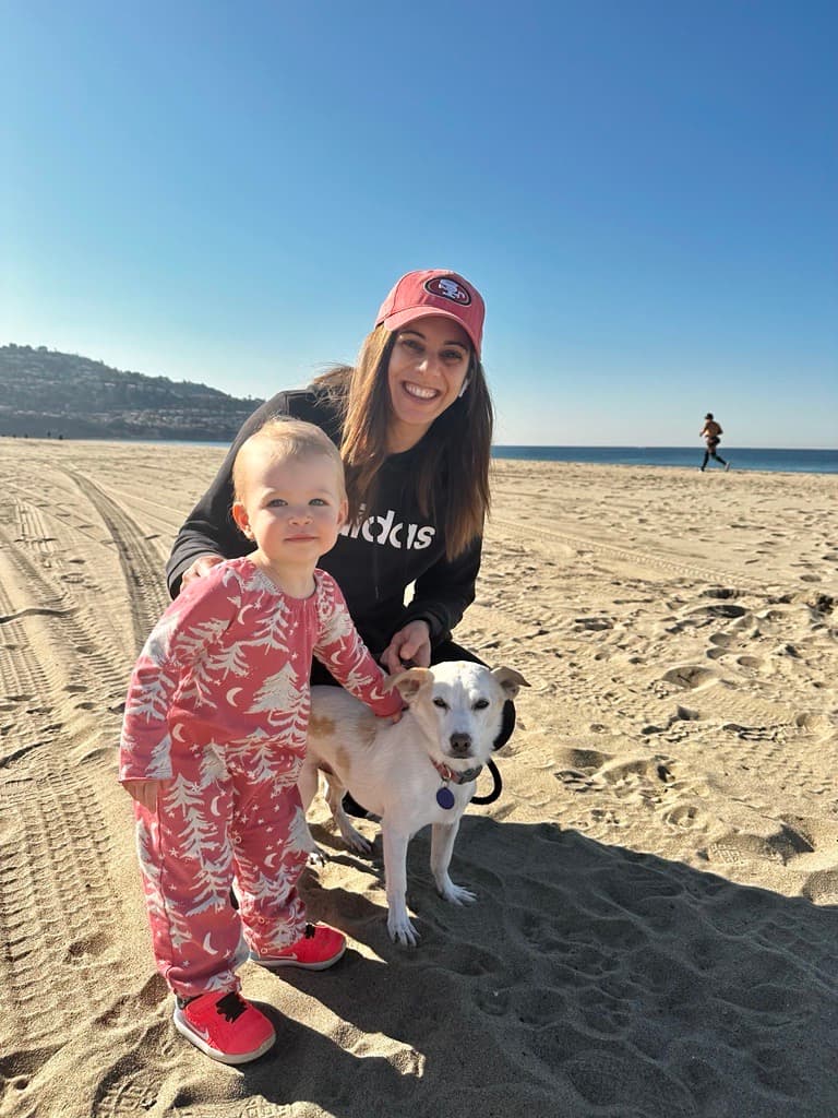 Redondo Beach Director Janine Strack with a child and dog on a beach 