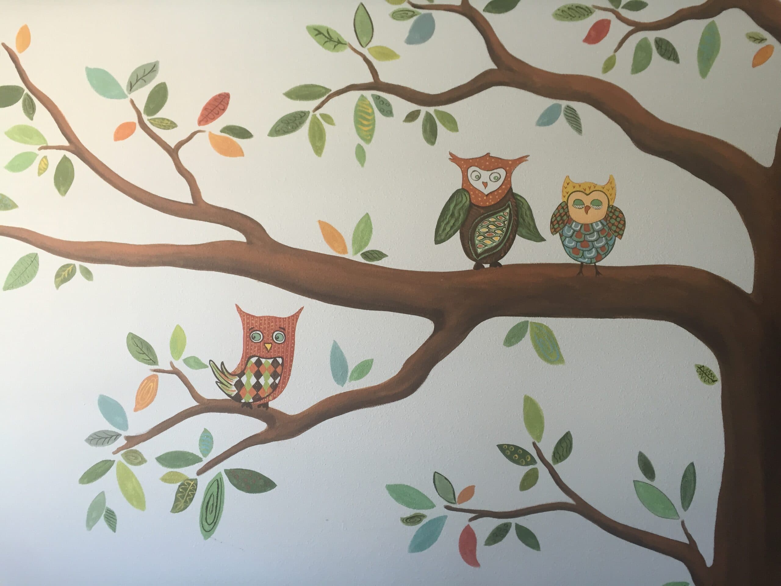 A drawing of owls sitting on a tree branch