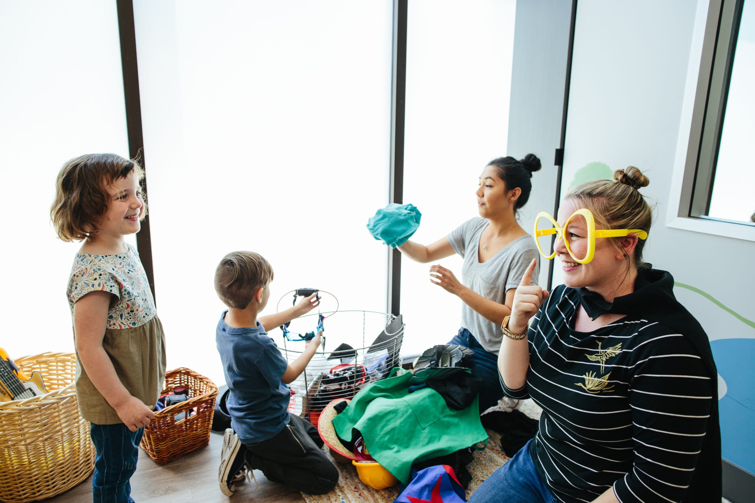Two women playing with toddlers