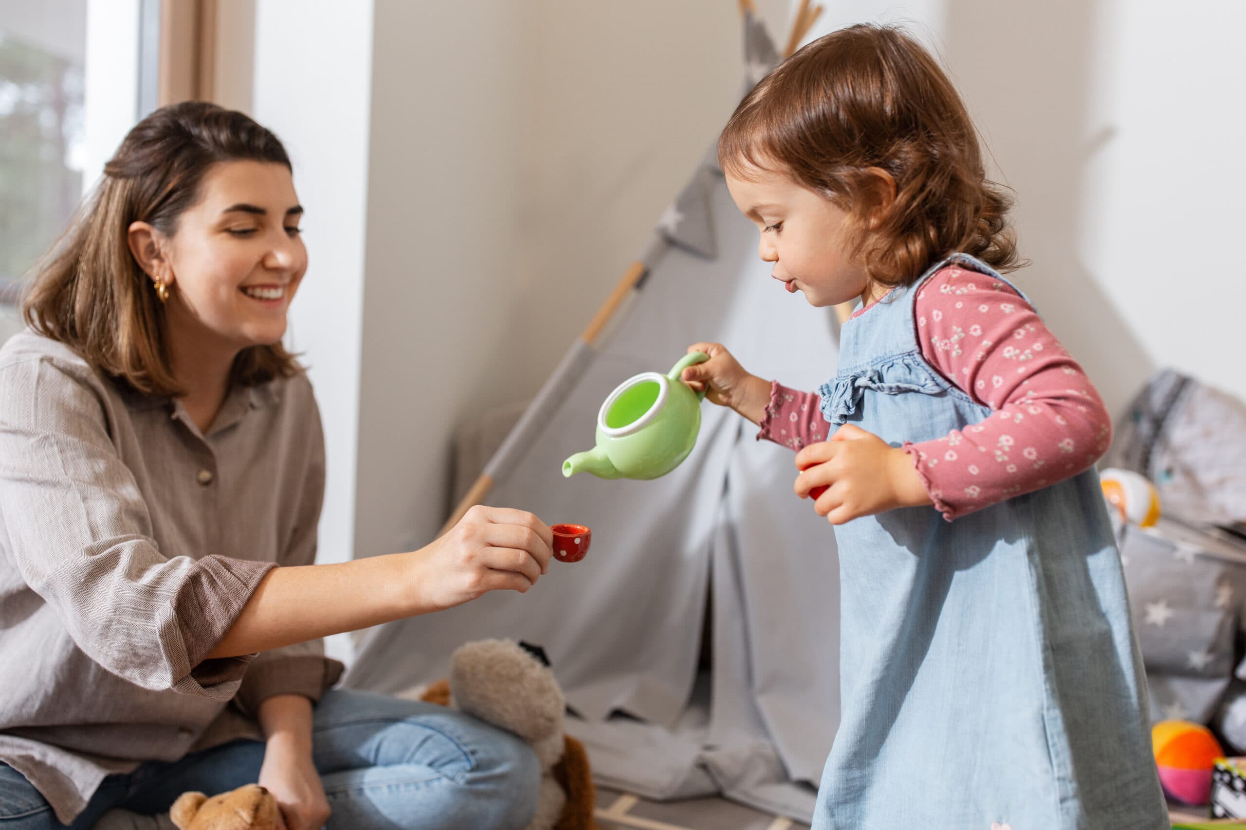 Woman and toddler having a tea party